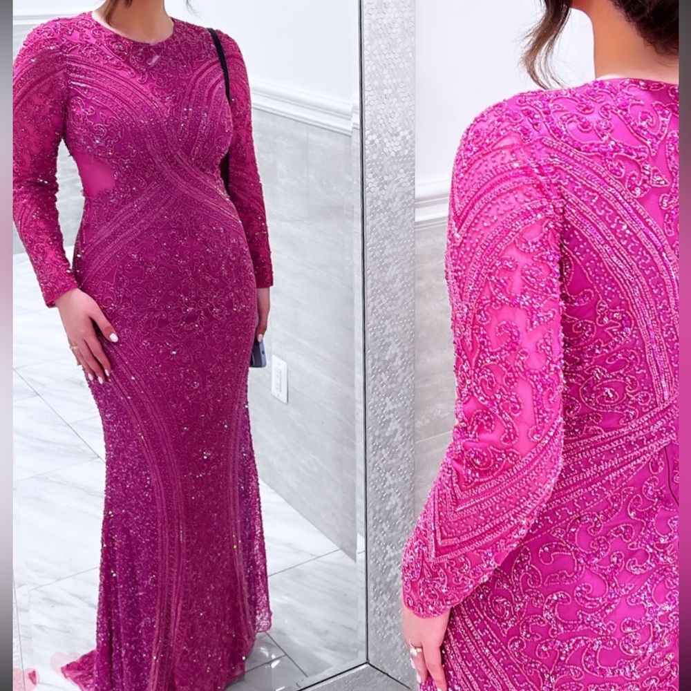 Pink embellished long sleeve unique gown. Fully lined. Sheer side cut.